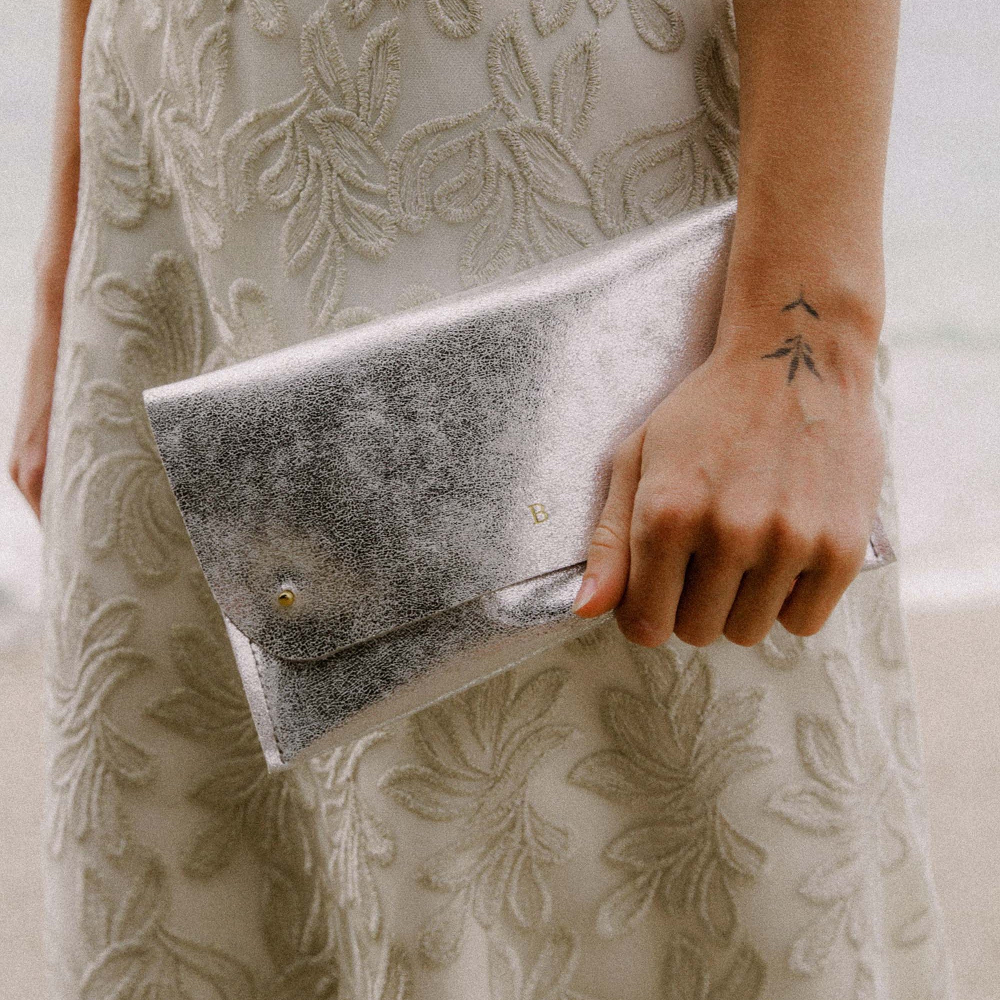 Silver Clutch Bag with personalisation, worn by bride.