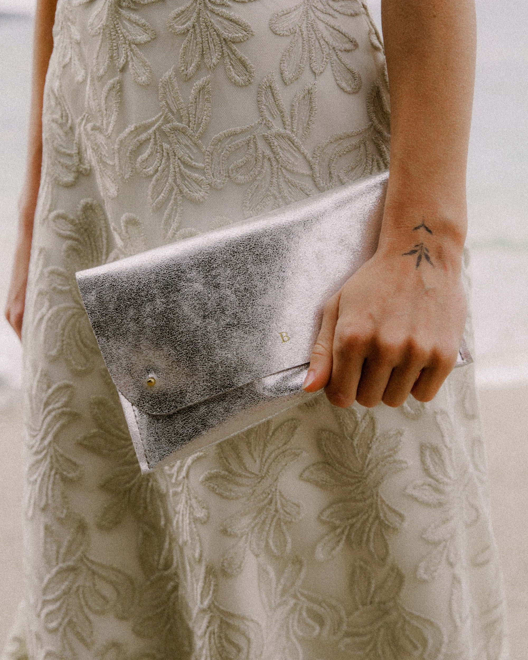 Silver Clutch Bag with personalisation, worn by bride.