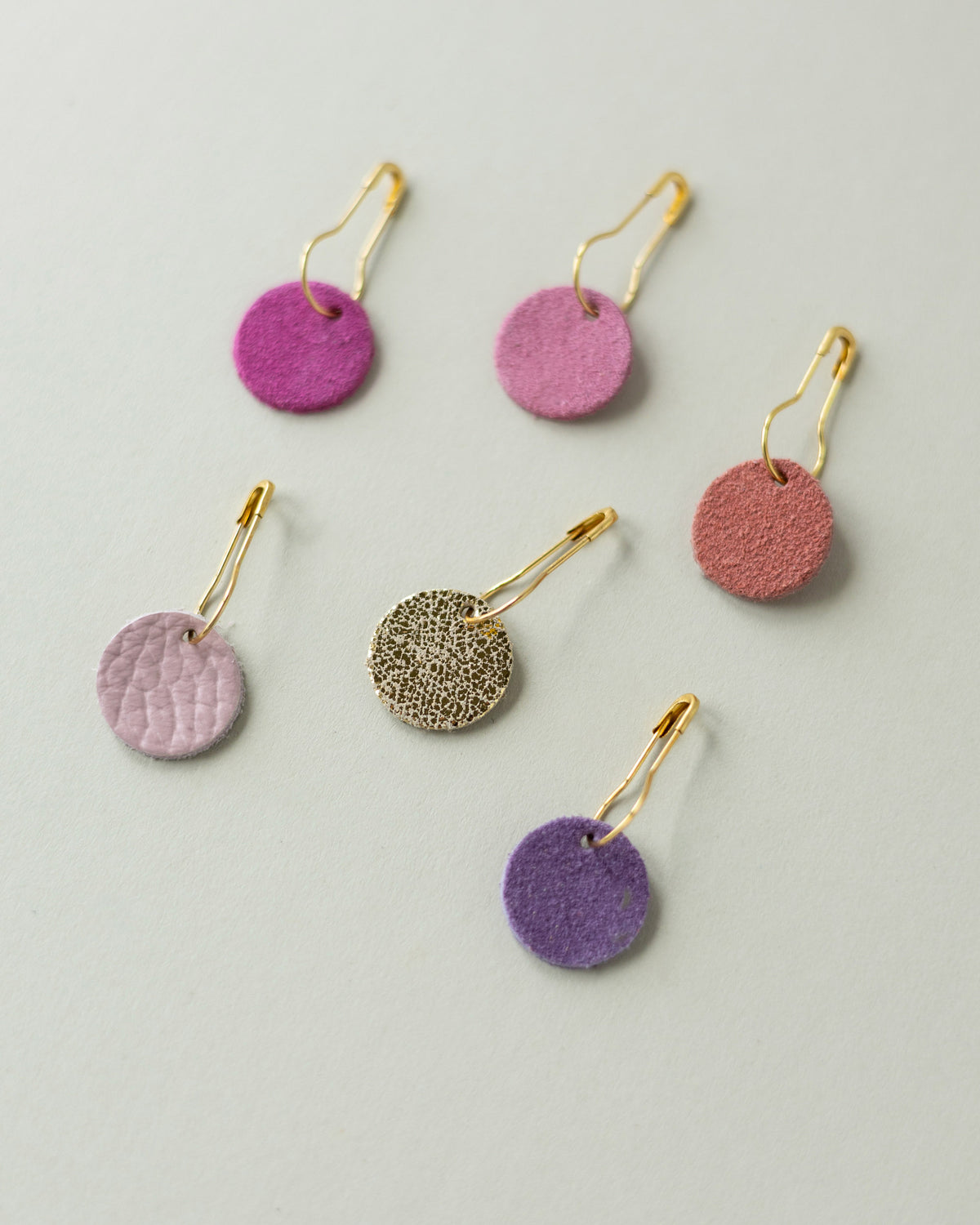 Colourful leather and suede stitch markers for knitting in pinks and purples