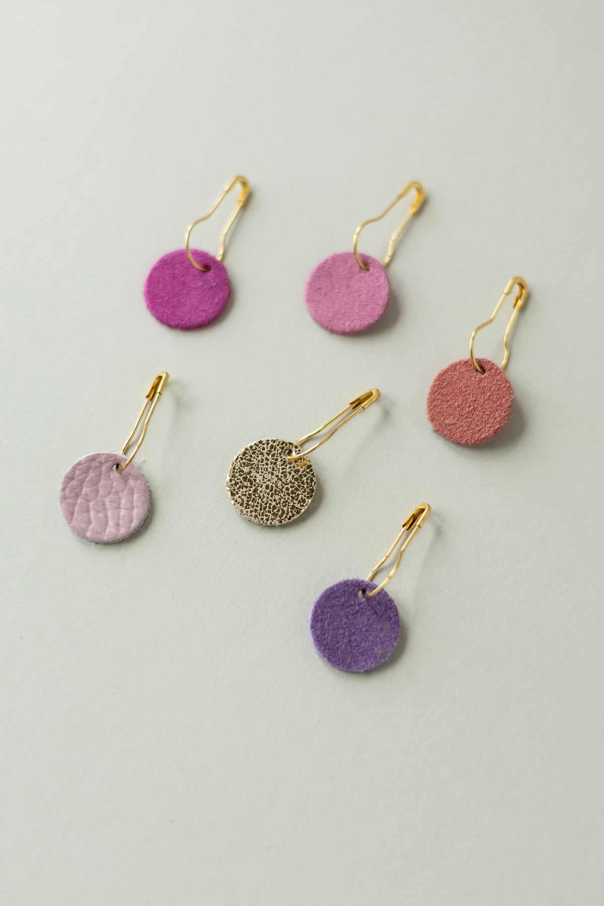 Colourful leather and suede stitch markers for knitting in pinks and purples