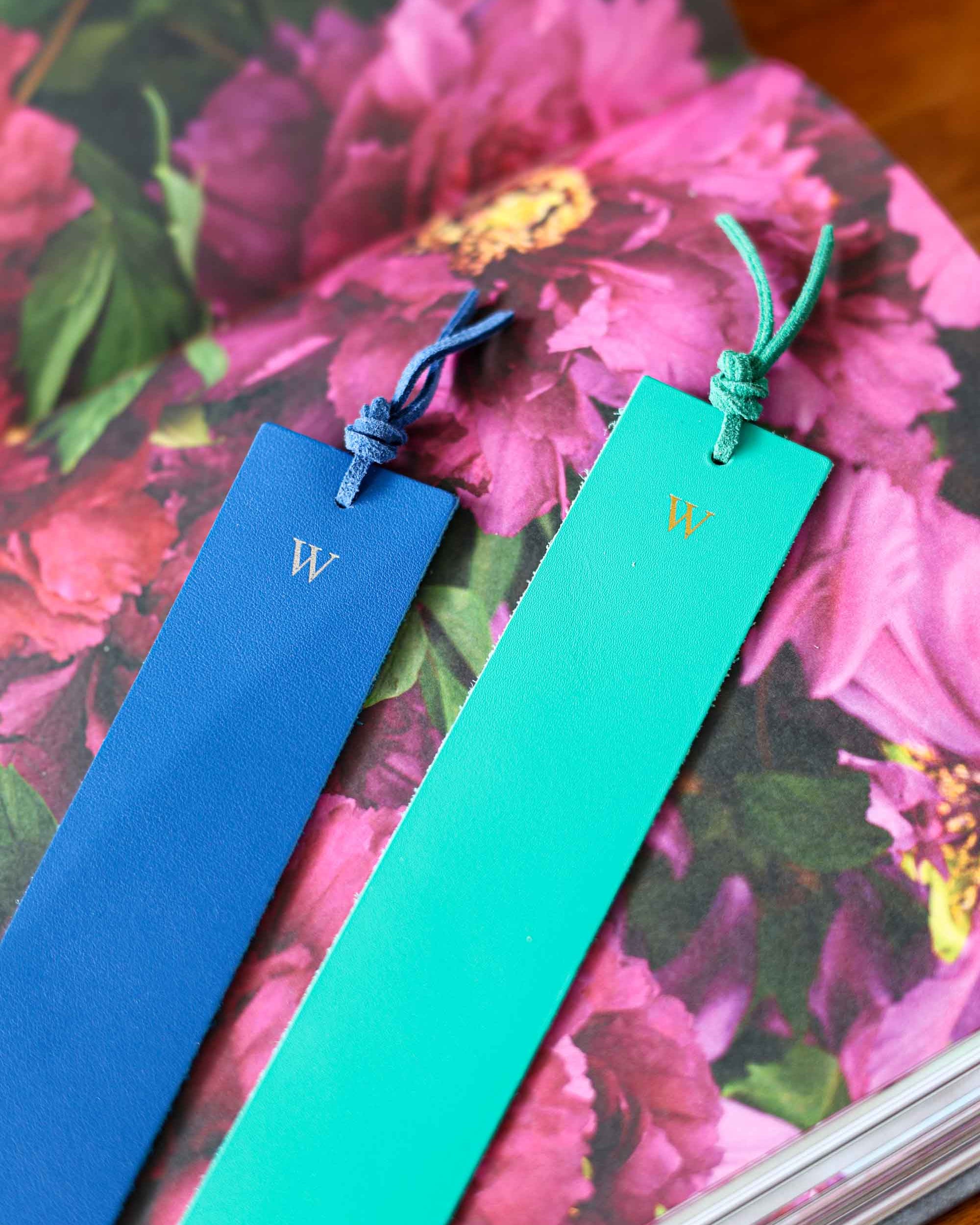 Two bookmarks, one blue and one green, with a 'W' on a floral background.