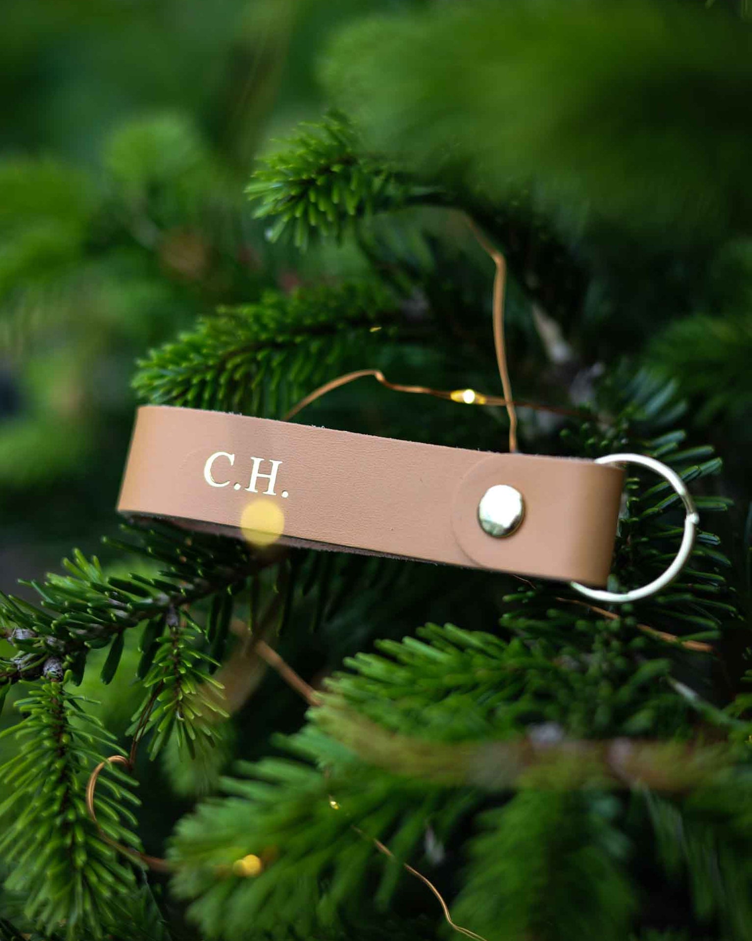 Brown leather keyring with initials C.H. on it.