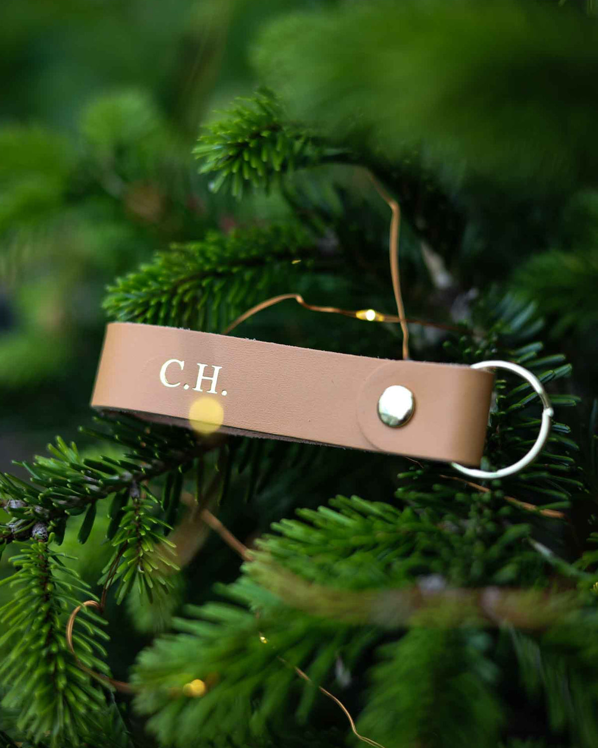 Brown leather keyring with initials C.H. on it.