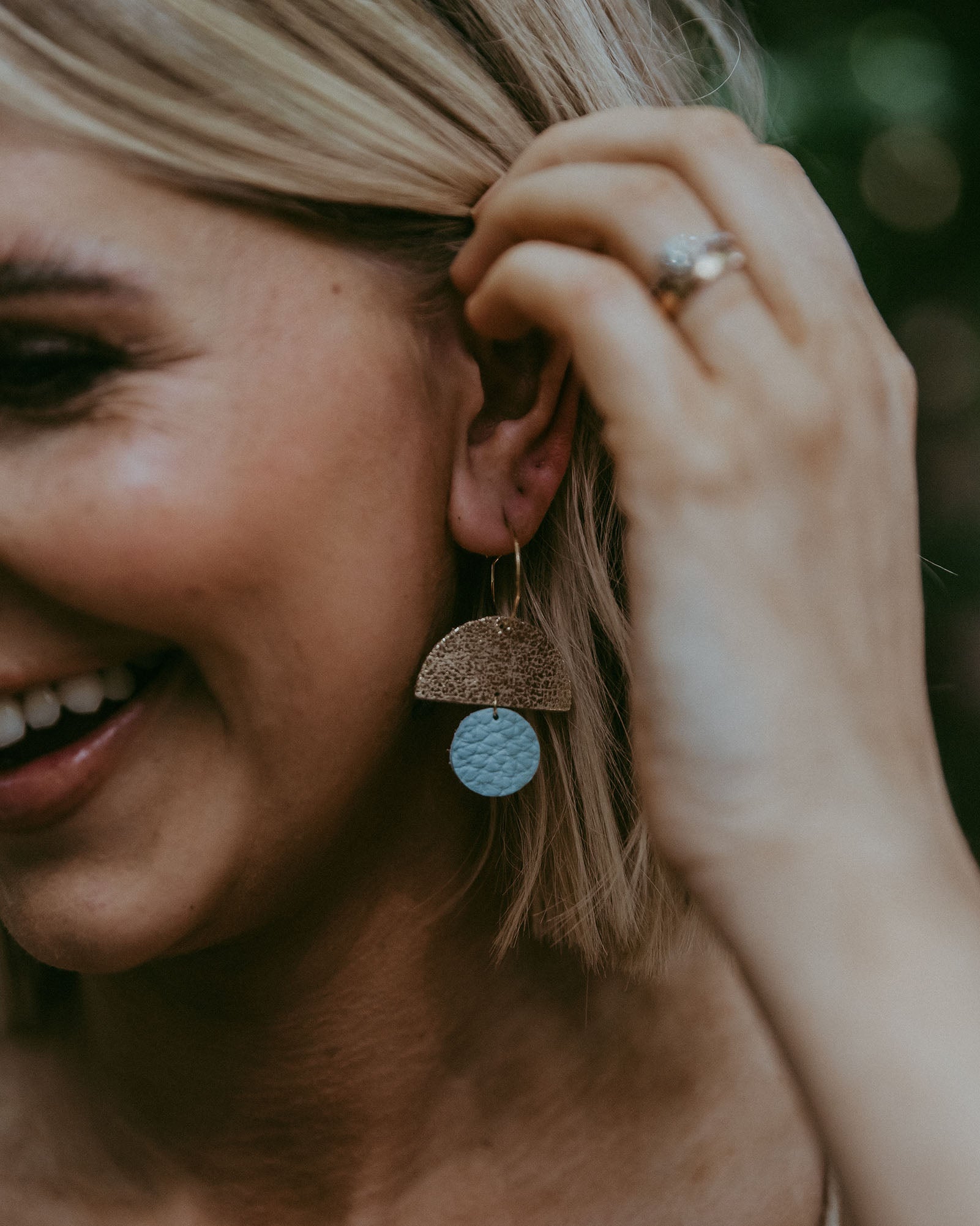 Modle wearing the sunrise hoops in seaglass.