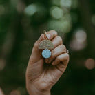 Model wearing the sunrise hoop earrings in seaglass colour