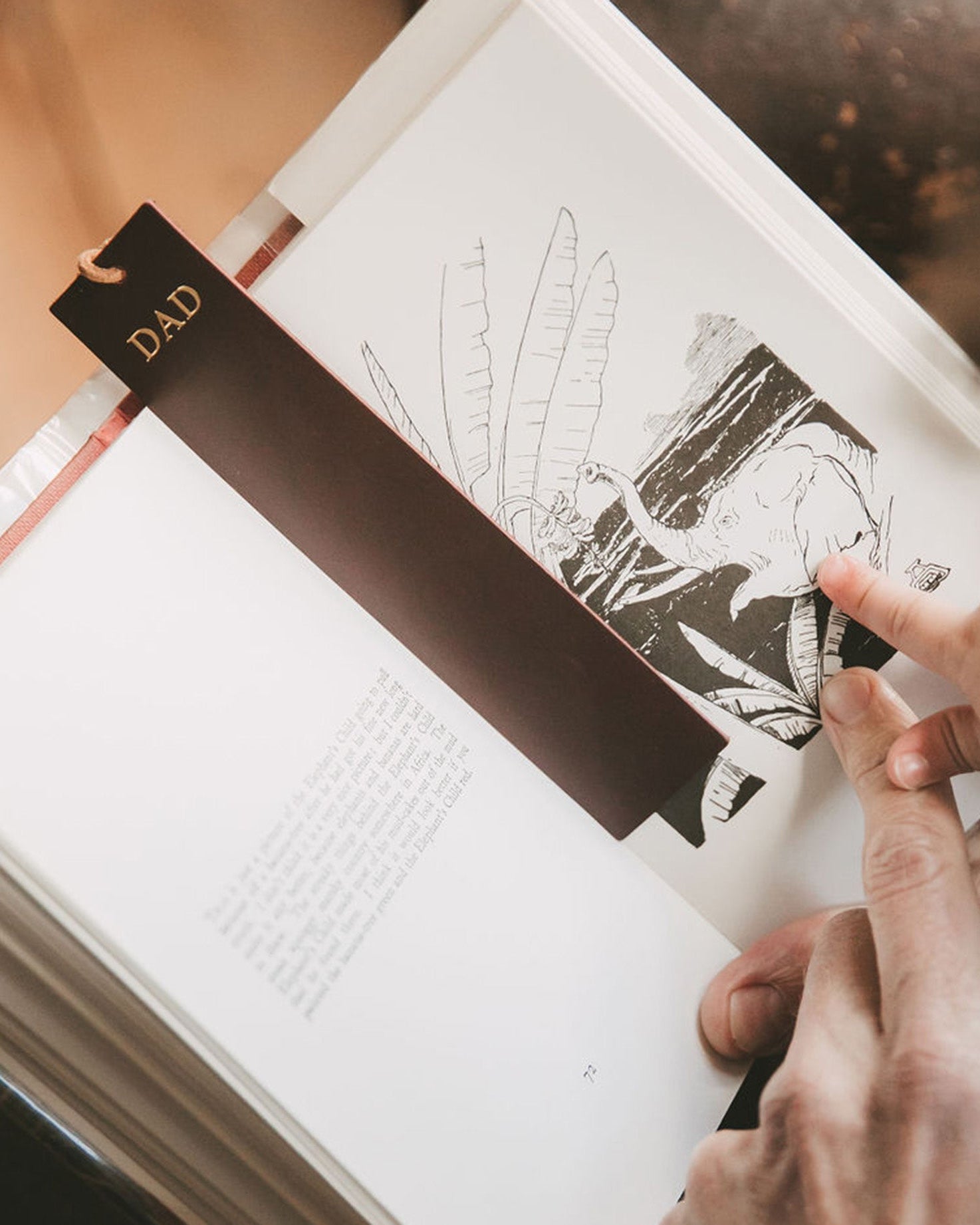 Brown leather bookmark on an open book.