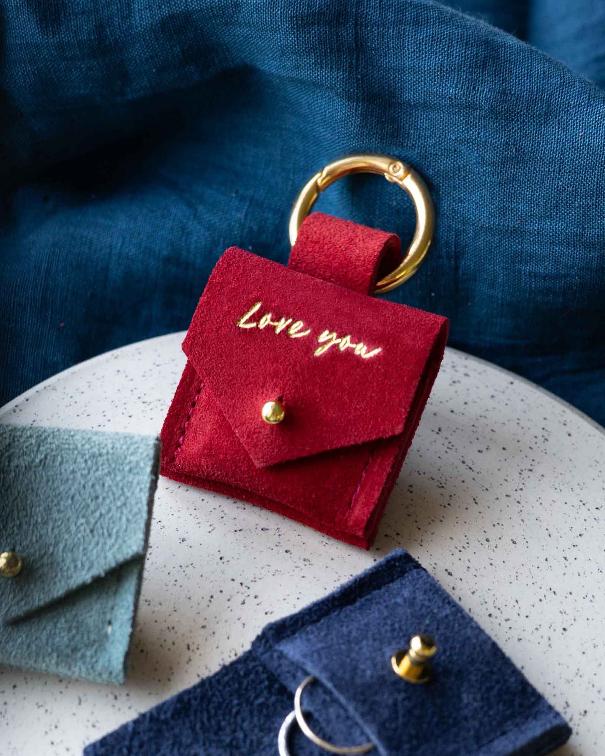 Red suede pouch with clip and "I love you" on it.