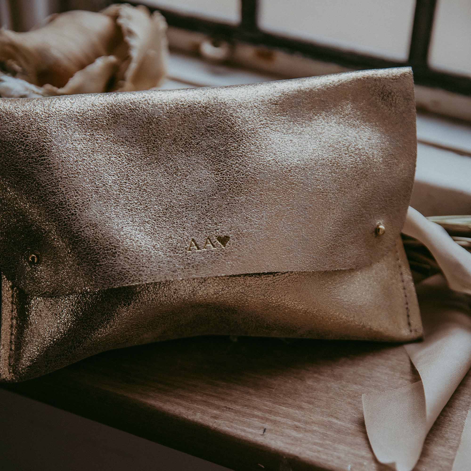 Personalised leather clutch bag in a shimmer bronze