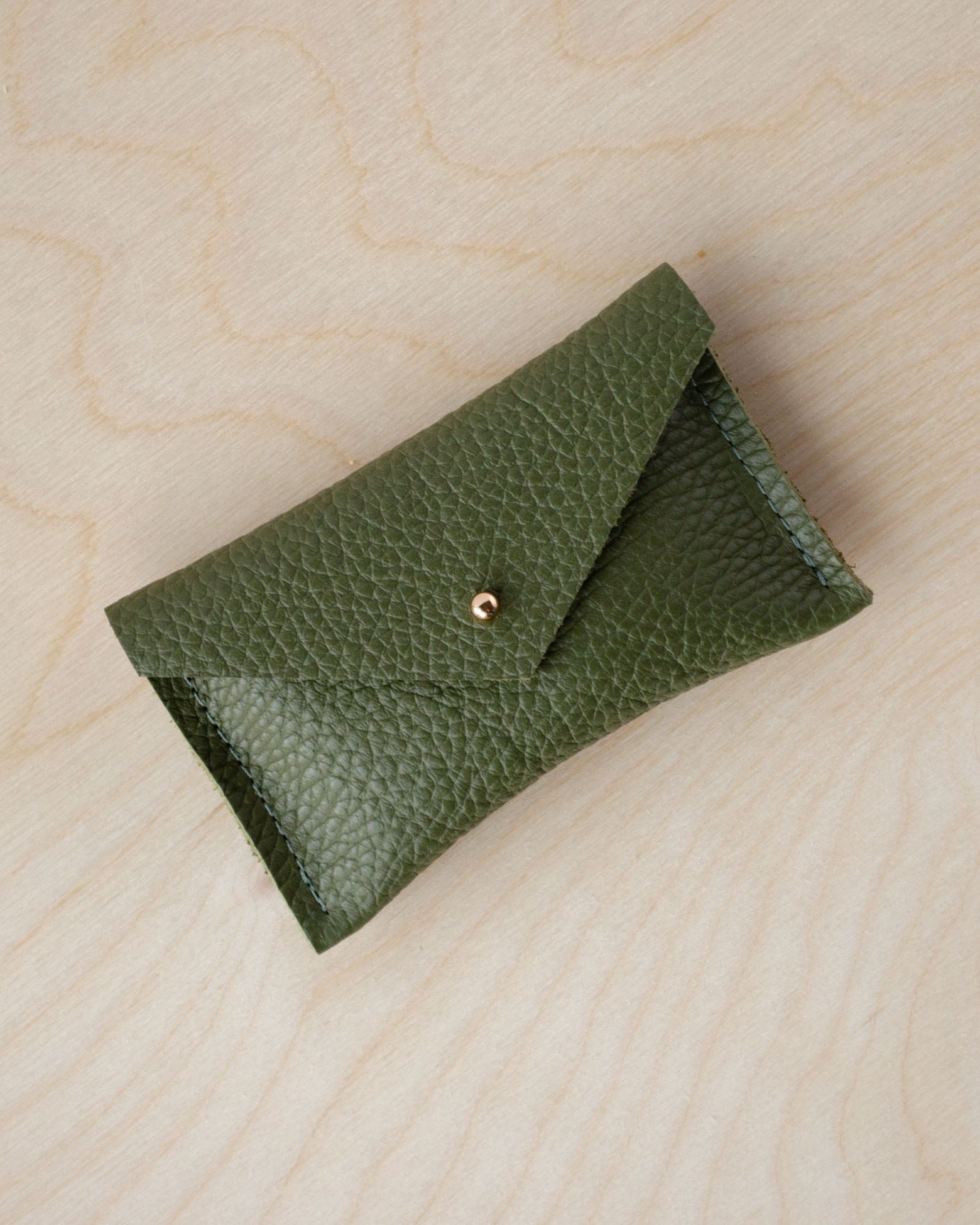 Olive green card wallet with envelope design and gold stud.