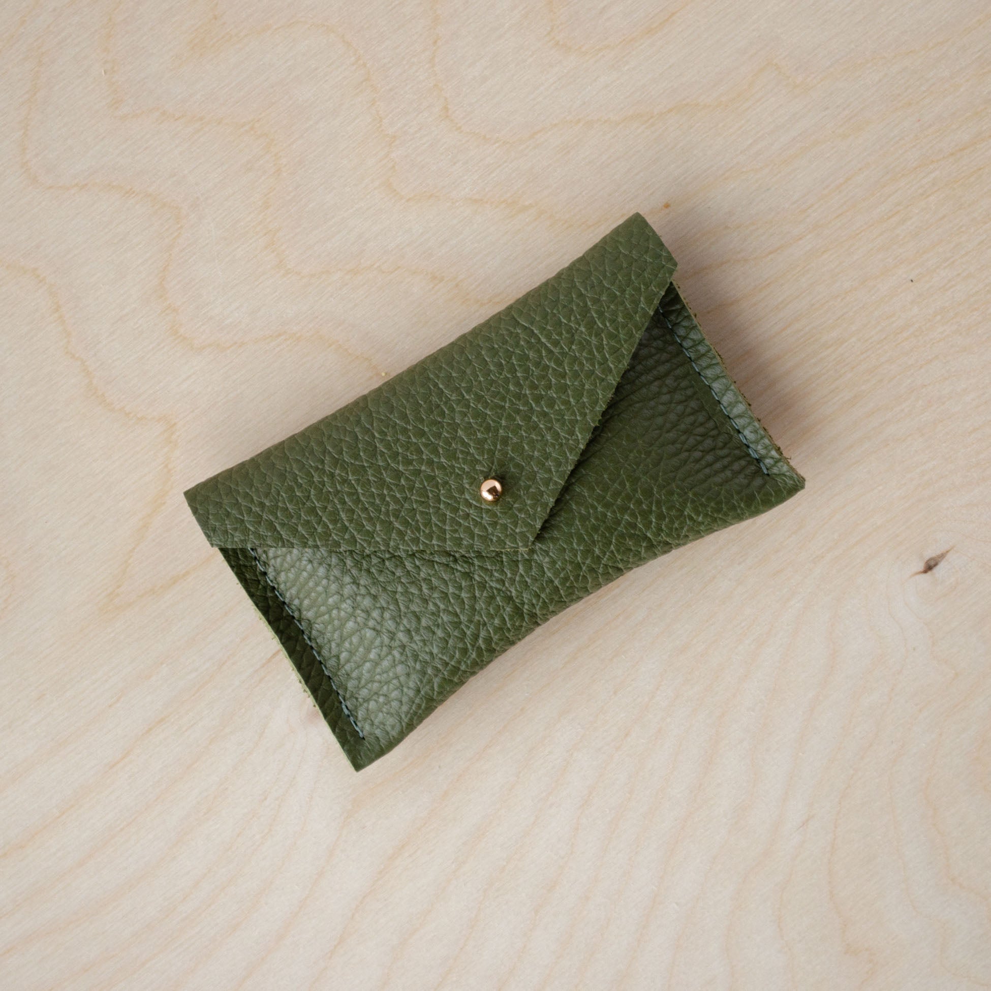 Olive green card wallet with envelope design and gold stud.