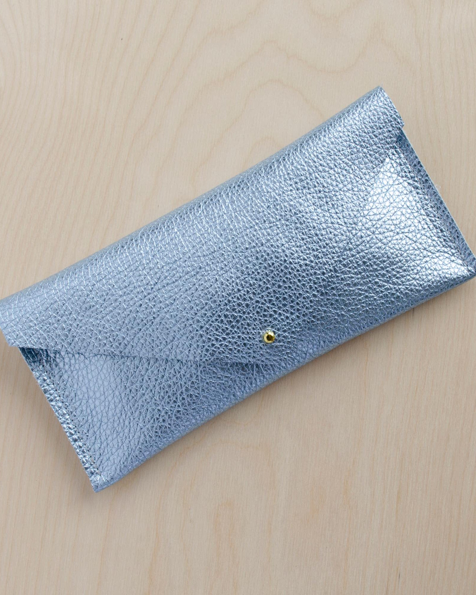Metallic diamond pale blue compact leather clutch bag with simple envelope design and gold fastening.