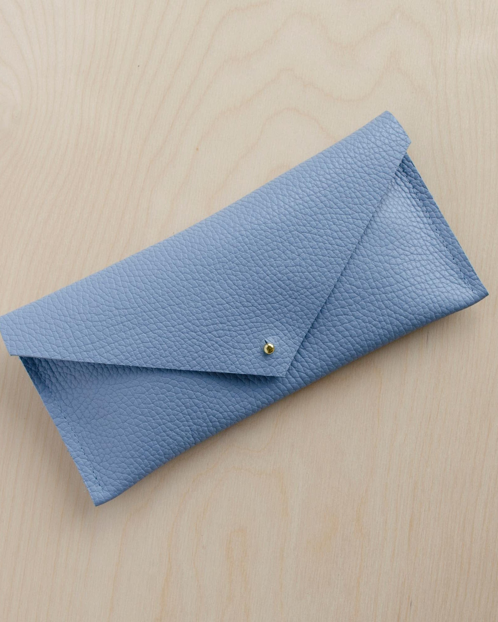 Powder blue clutch purse with envelope shape design.