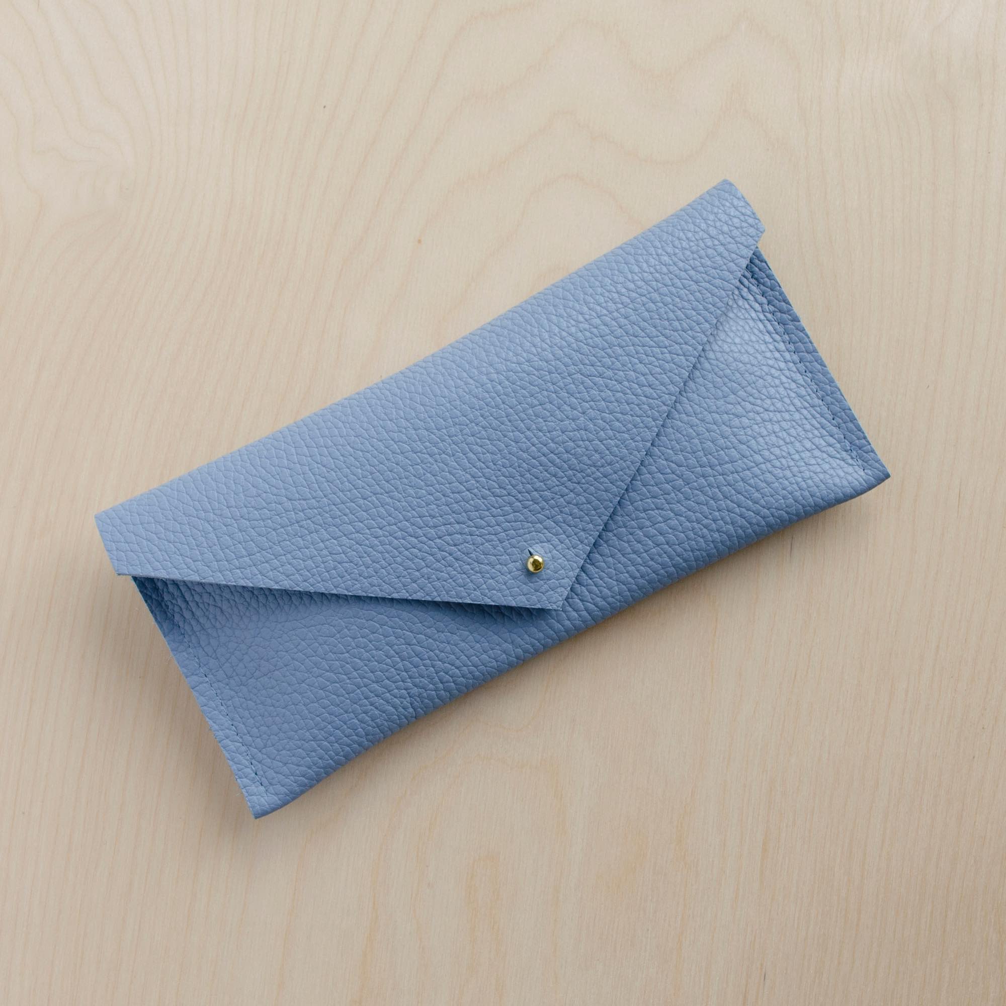 Powder blue clutch purse with envelope shape design.