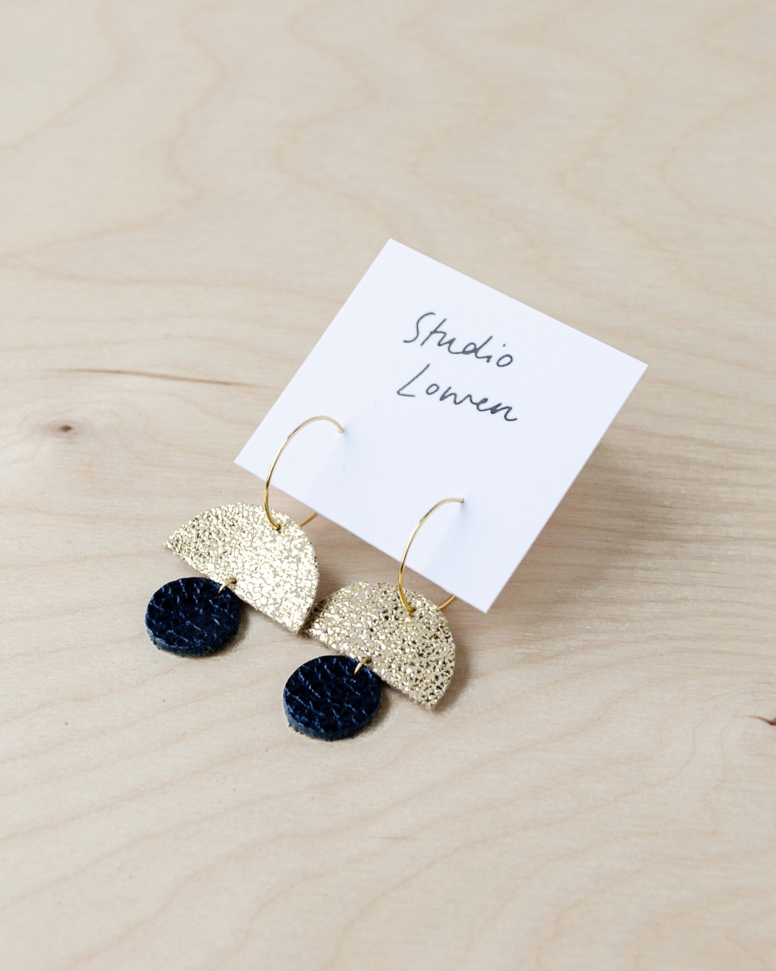 Sunrise hoop earrings in black leather and shimmer gold