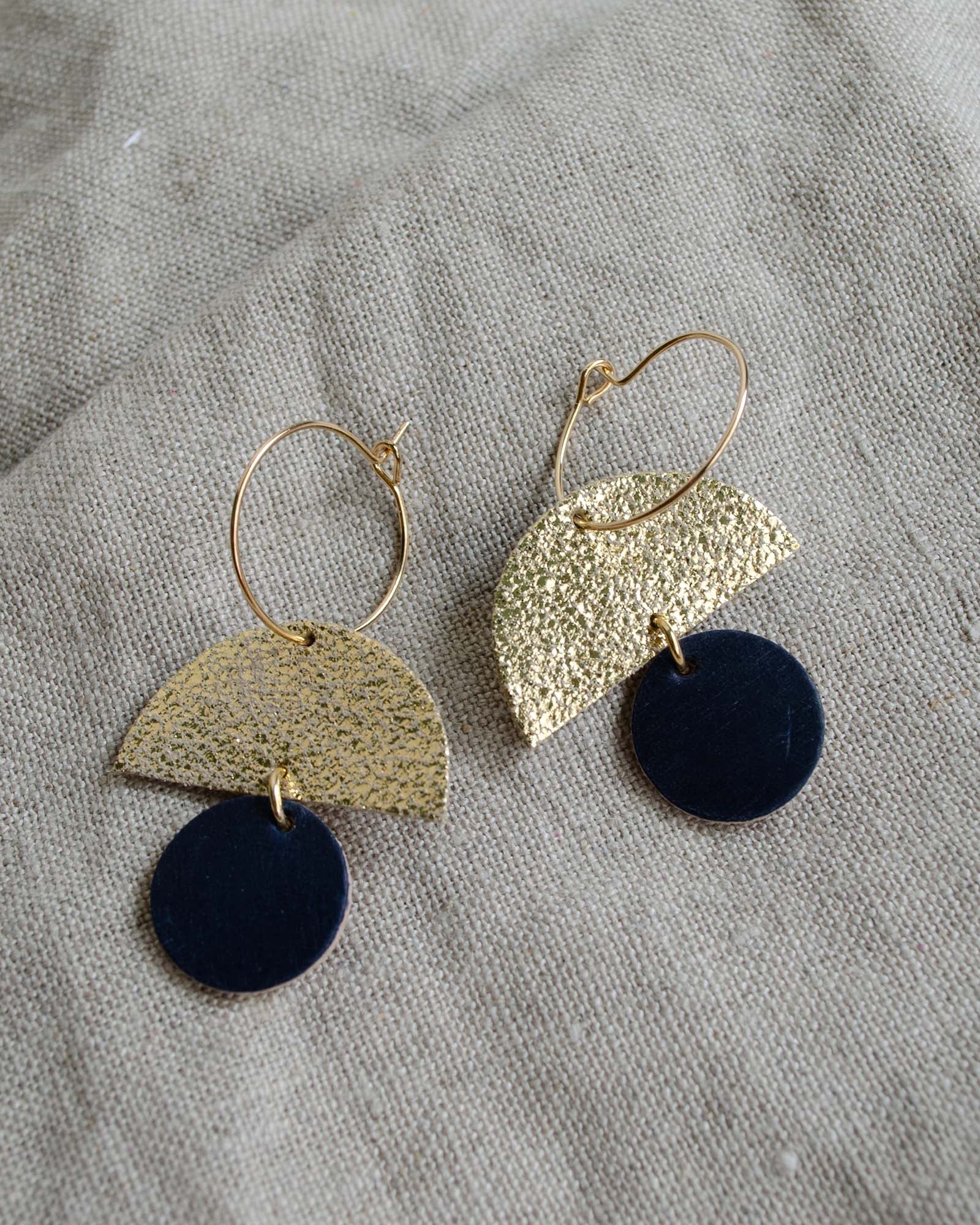 The sunrise hoop earrings in black leather.
