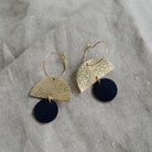 The sunrise hoop earrings in black leather.