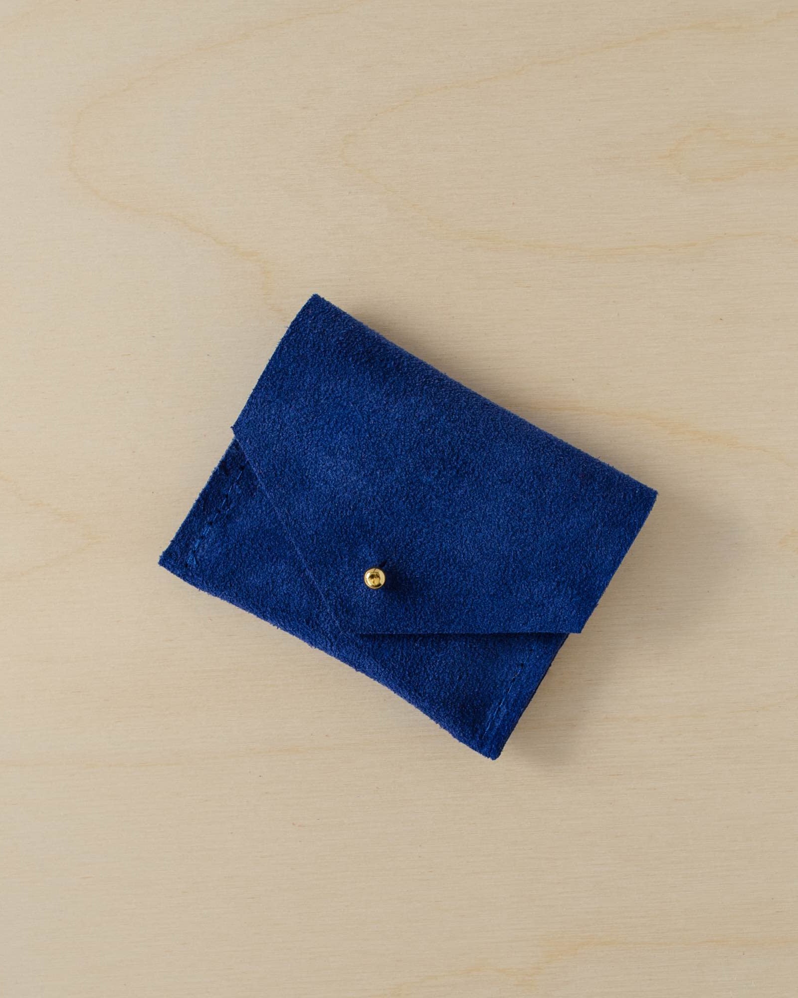 Bright royal blue suede jewellery pouch with gold stud fastening.