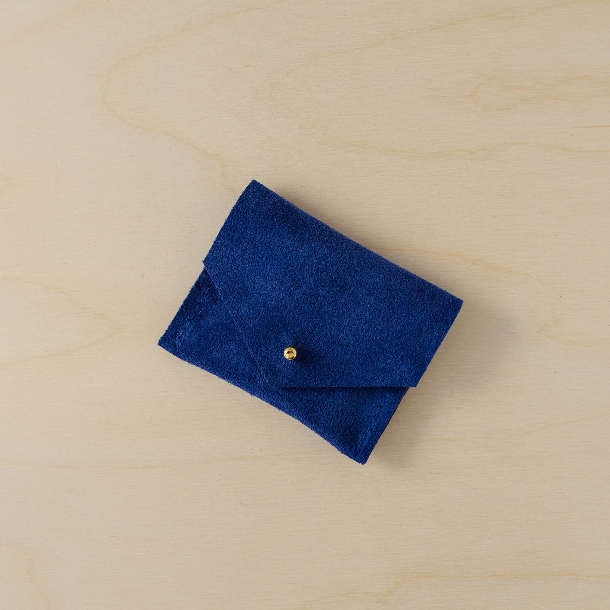 Bright royal blue suede jewellery pouch with gold stud fastening.