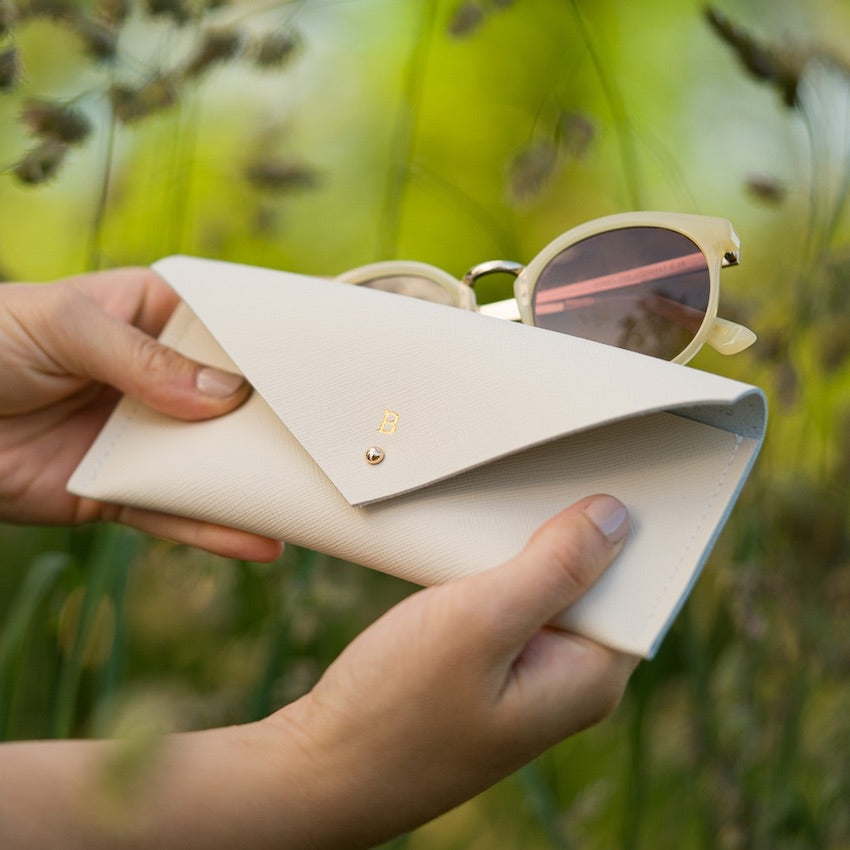 Cream recycled leather glasses case with cream sunglasses.