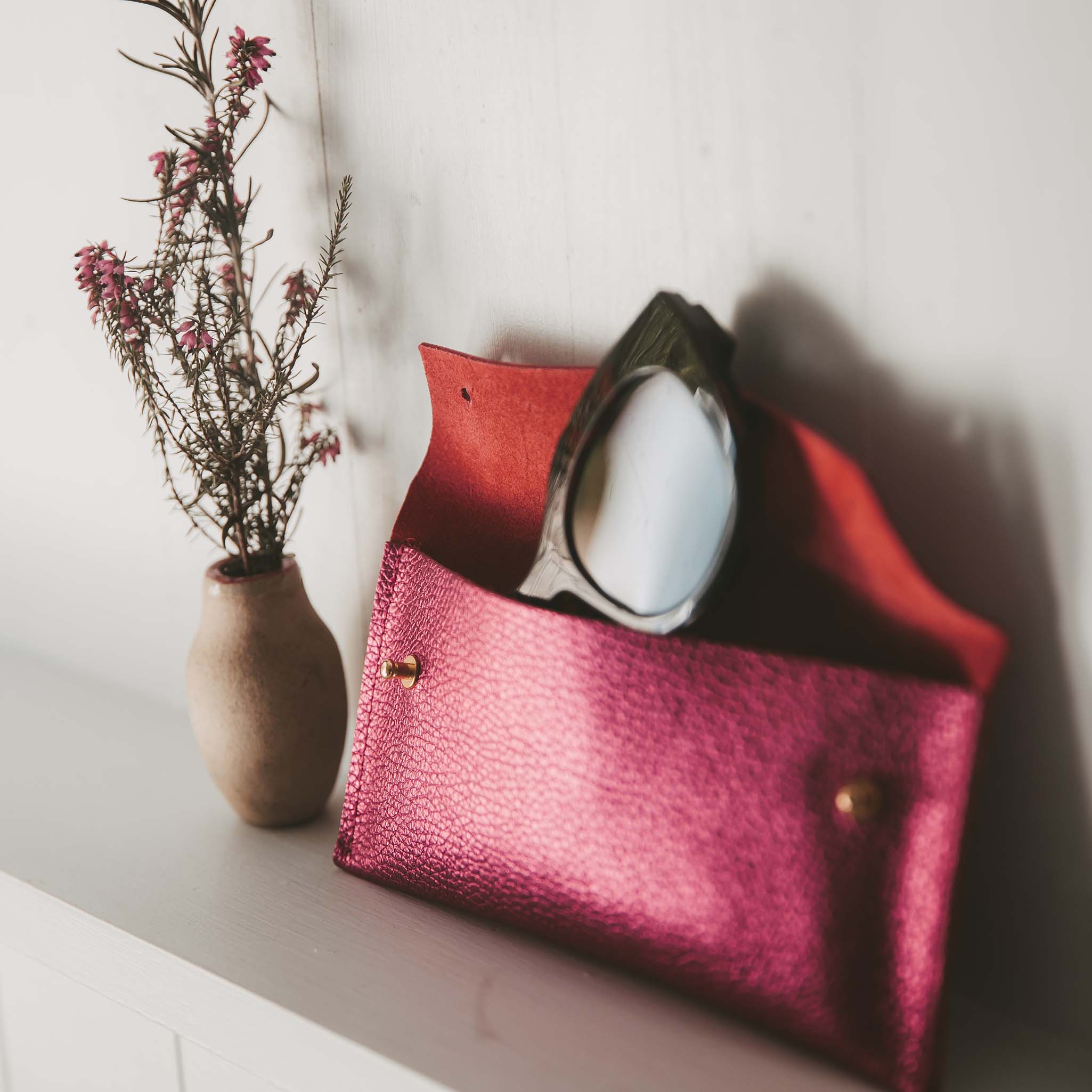 Cream recycled leather glasses case with cream sunglasses.