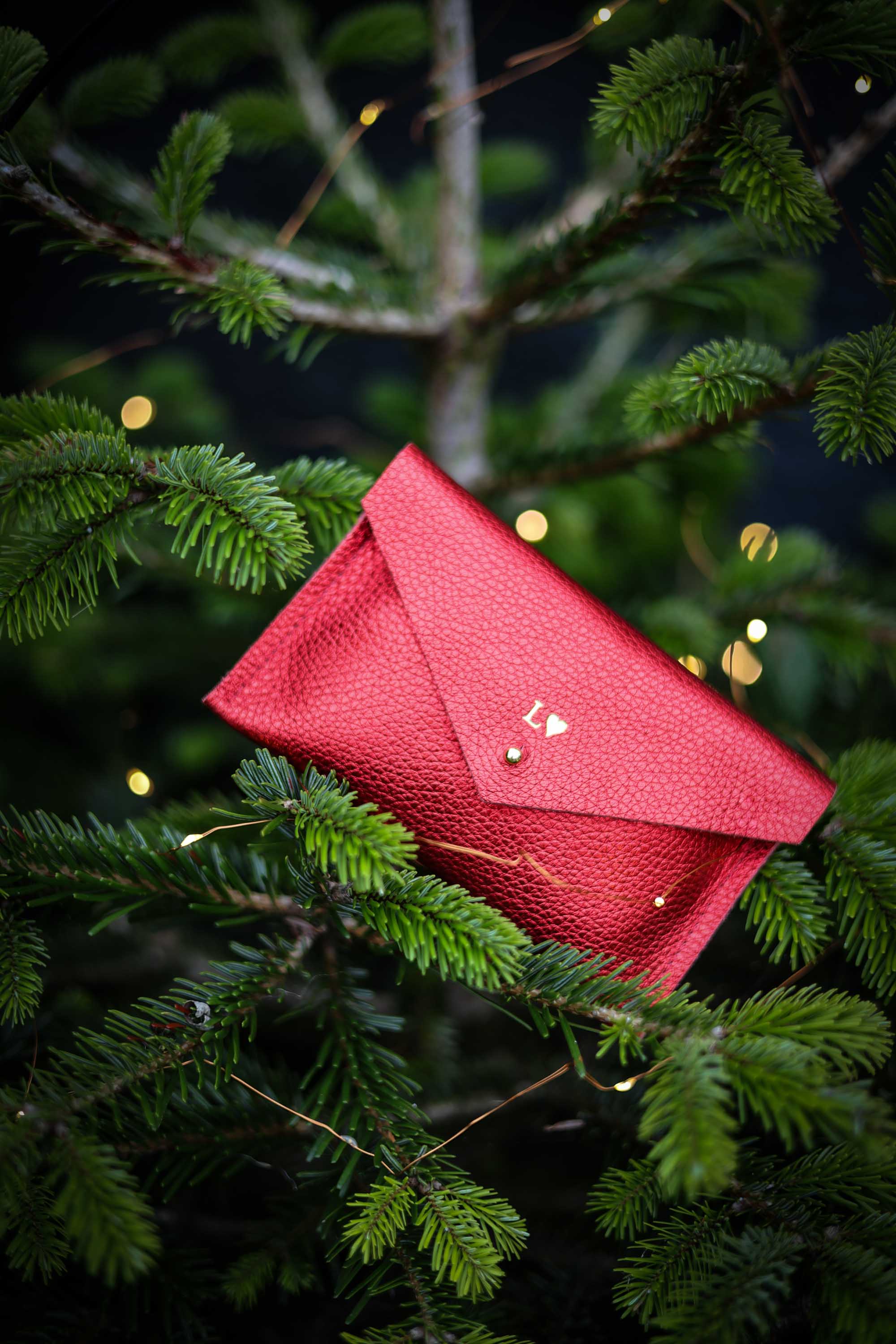 Red purse with initials on the front in a Christmas tree.