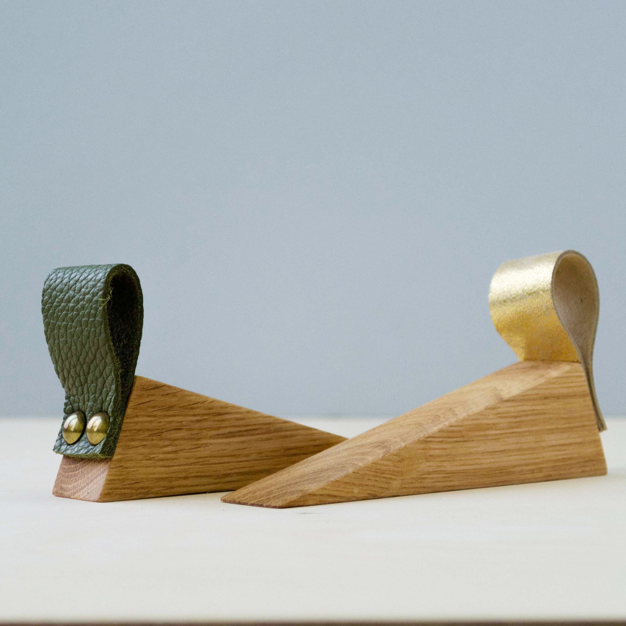 Wooden door wedge with olive green and gold leather strap.