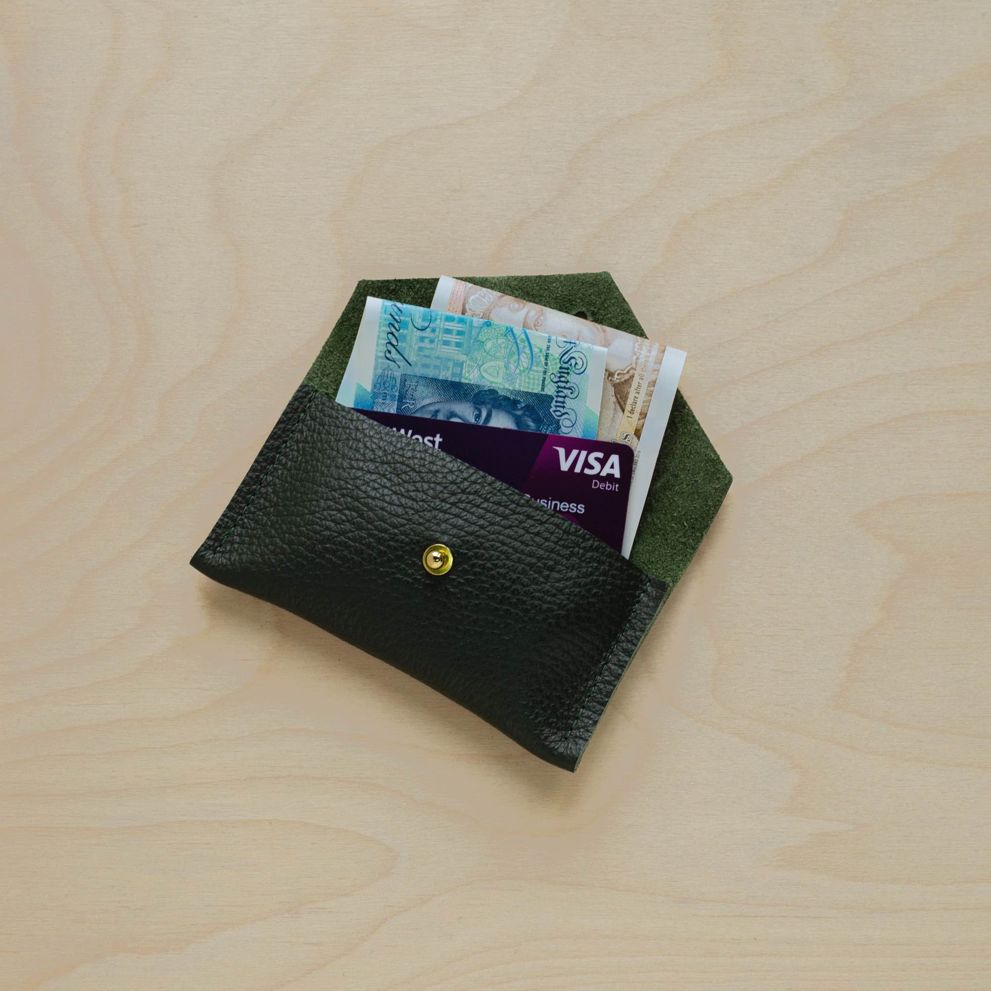 Pine Green leather card holder in use.