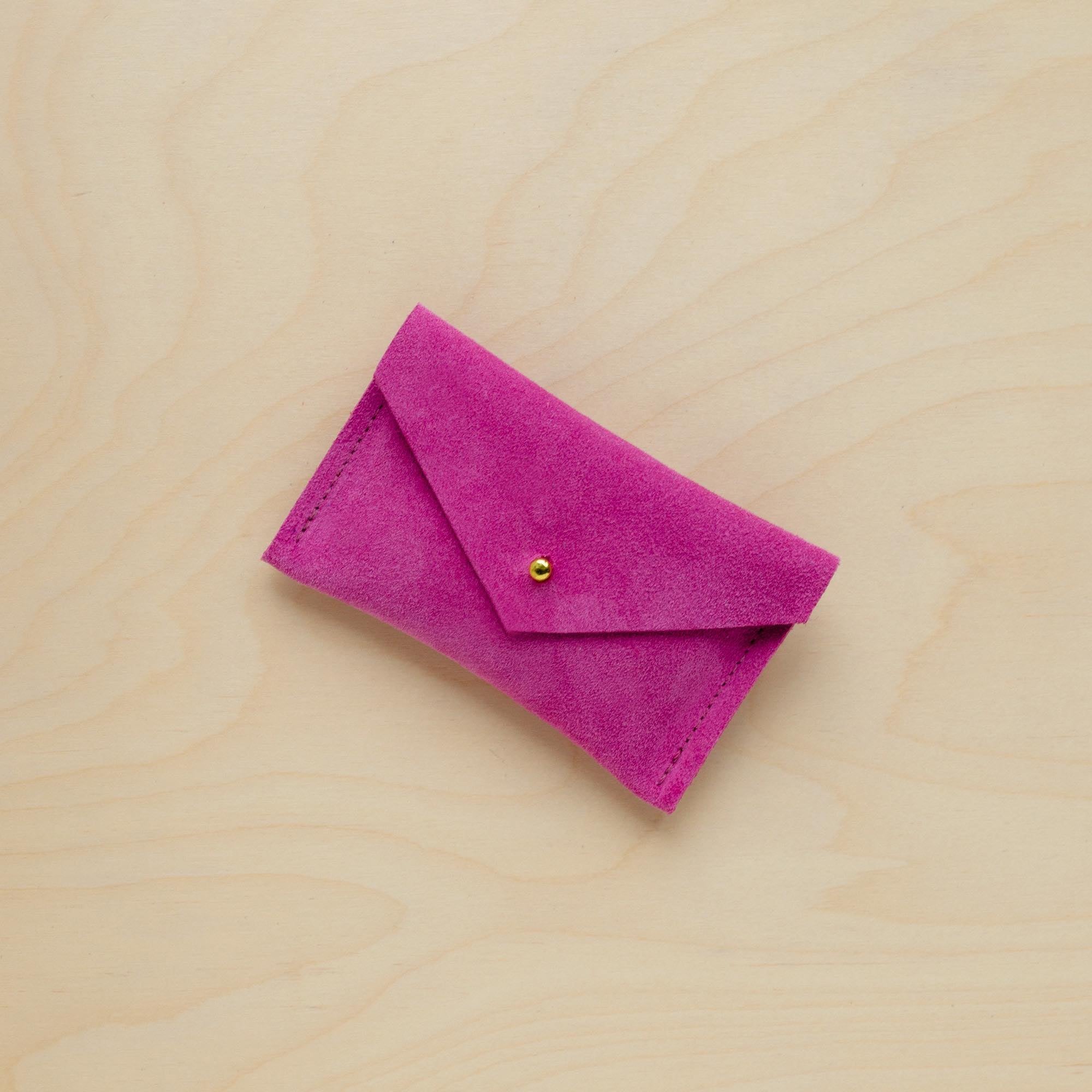 A suede Small Notions Pouch in Fuchsia Pink. Complete with a stud for secure closing.