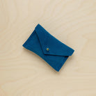 A suede Small Notions Pouch in Teal Green. Complete with a stud for secure closing.