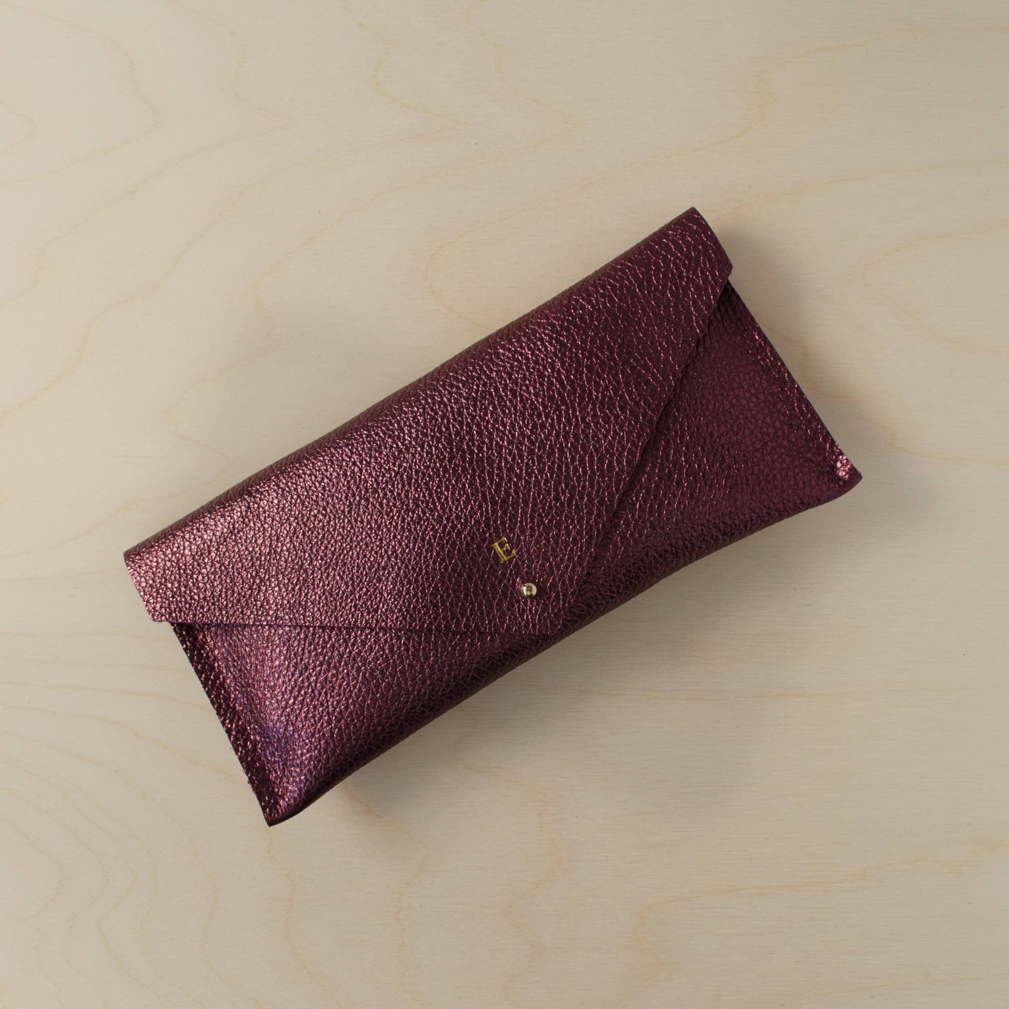 Personalised leather clutch bag in metallic berry