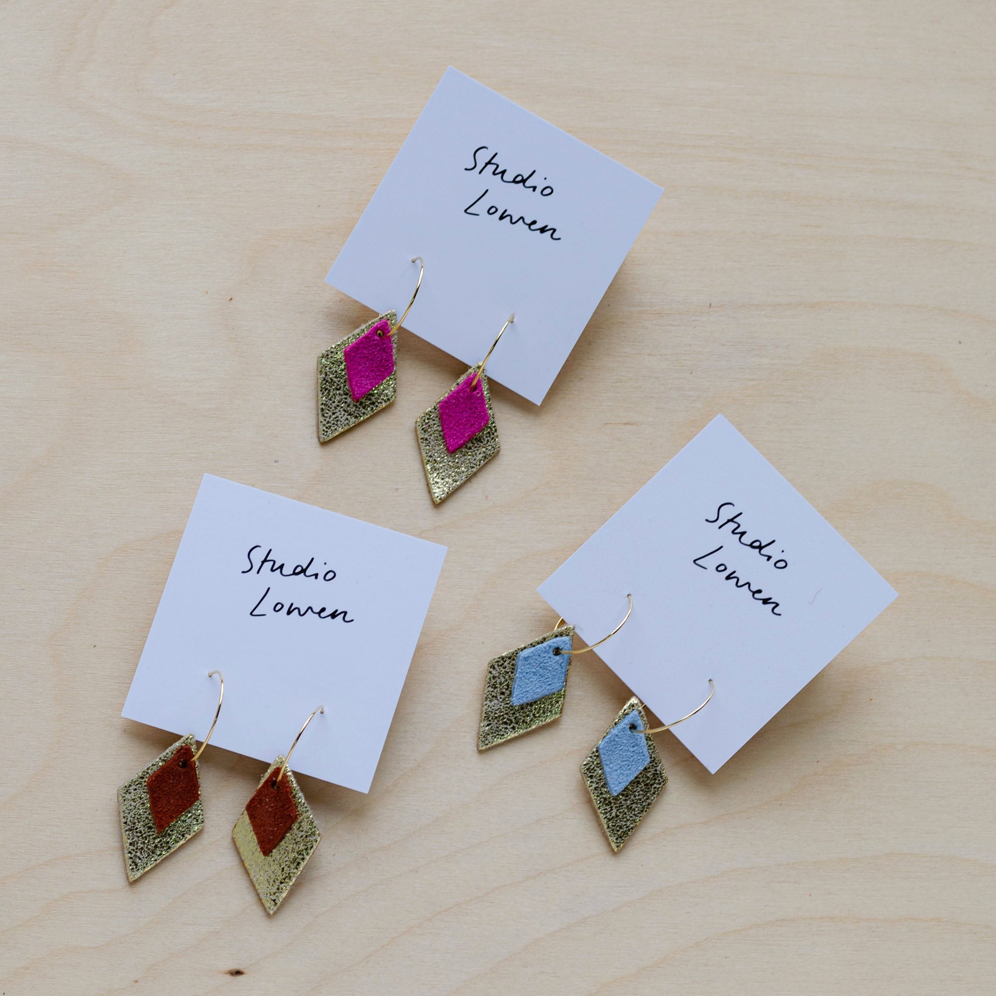 Three pairs of the Bea Hoop earrings in Fuchsia pink, Pale Blue and Chestnut Brown