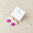 Sunrise Hoop leather earrings in gold and fuchsia pink.