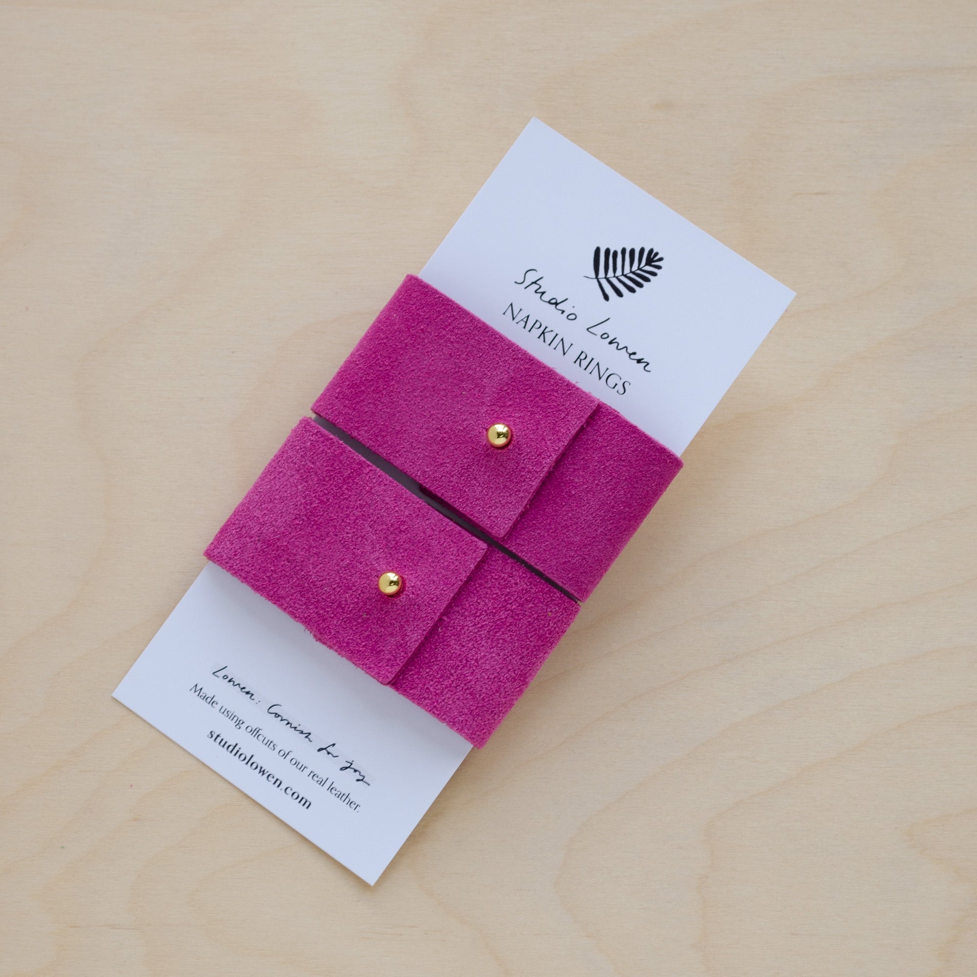 Pair of Bright fuchsia pink suede napkin rings with gold stud.