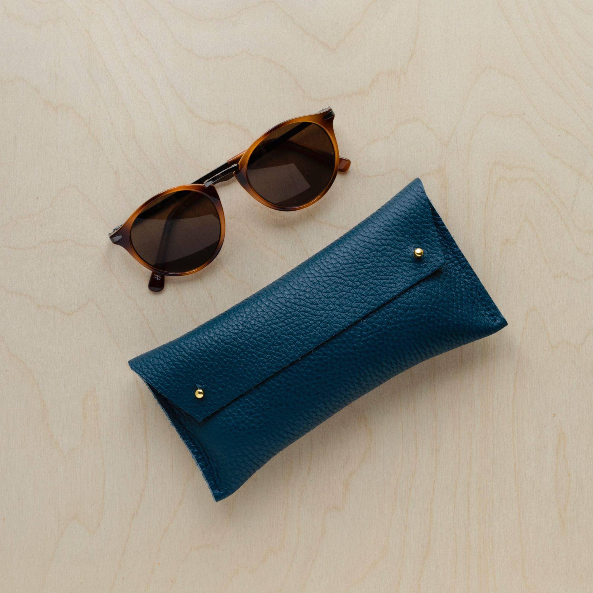 Double Stud Glasses case in Atlantic teal with sunglasses.