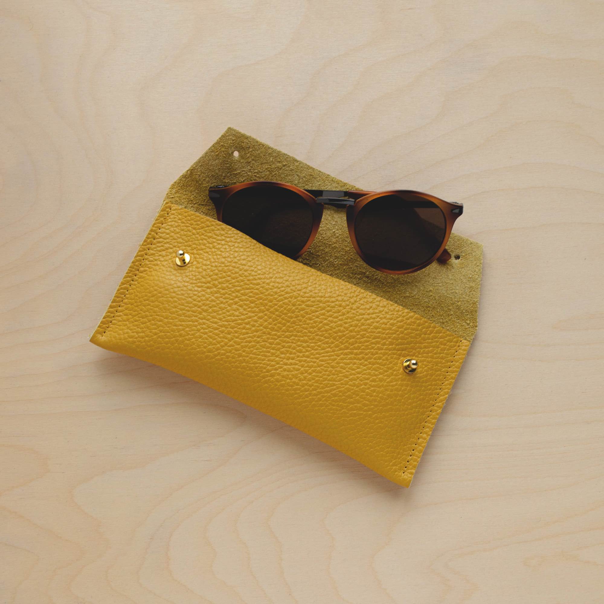 Mustard Yellow leather glasses case with sunglasses.