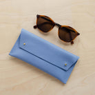 Powder Blue leather glasses case with sunglasses.