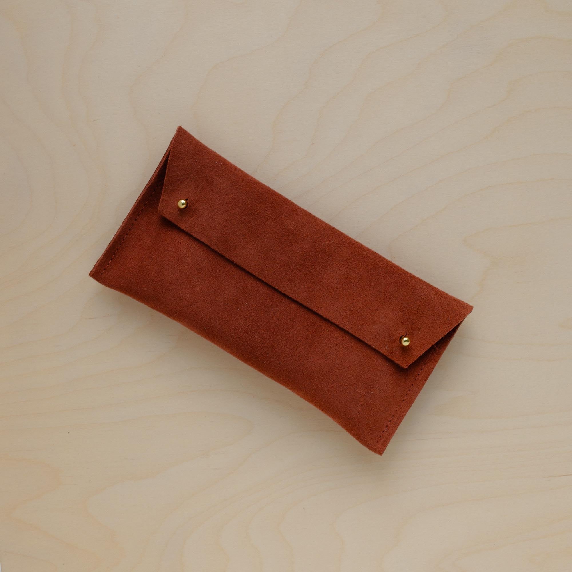 The suede pen case in Chestnut Brown. Featuring a double stud. 