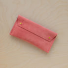 The suede pen case in Coral Pink. Featuring a double stud. 