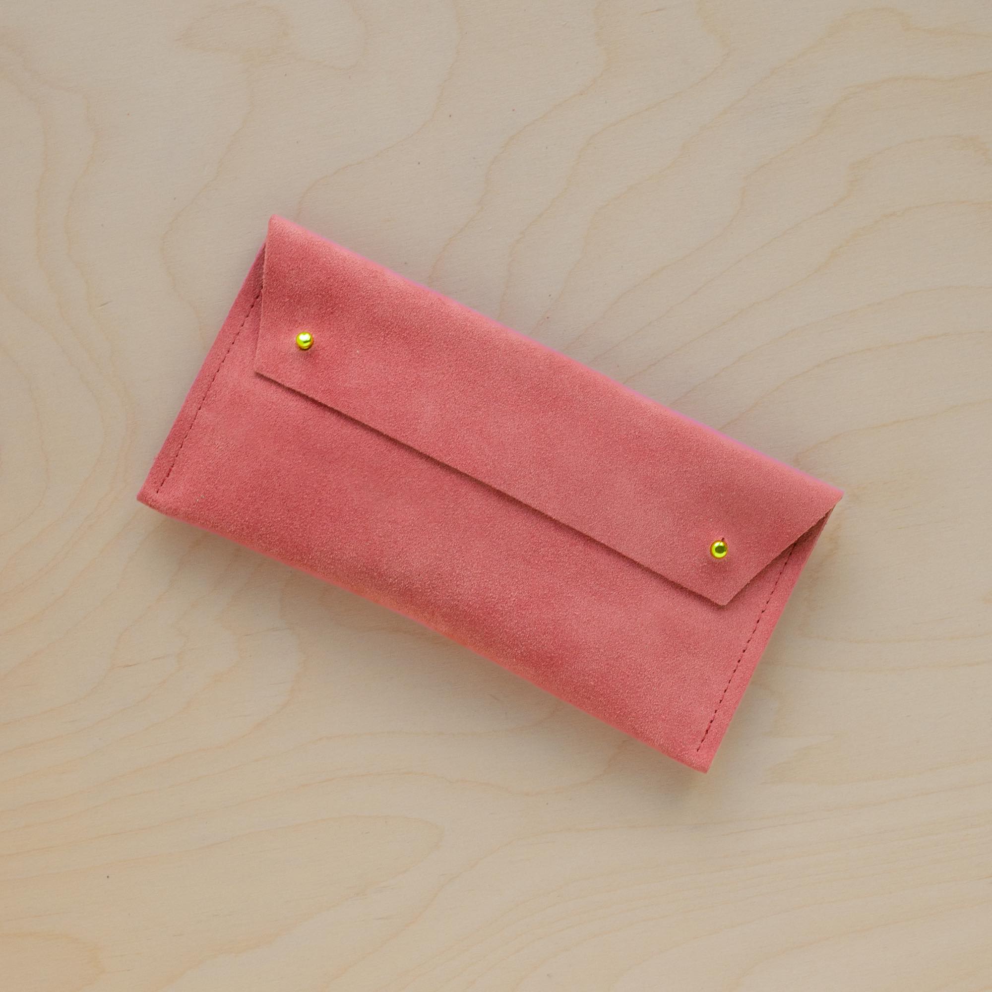 The suede pen case in Coral Pink. Featuring a double stud. 