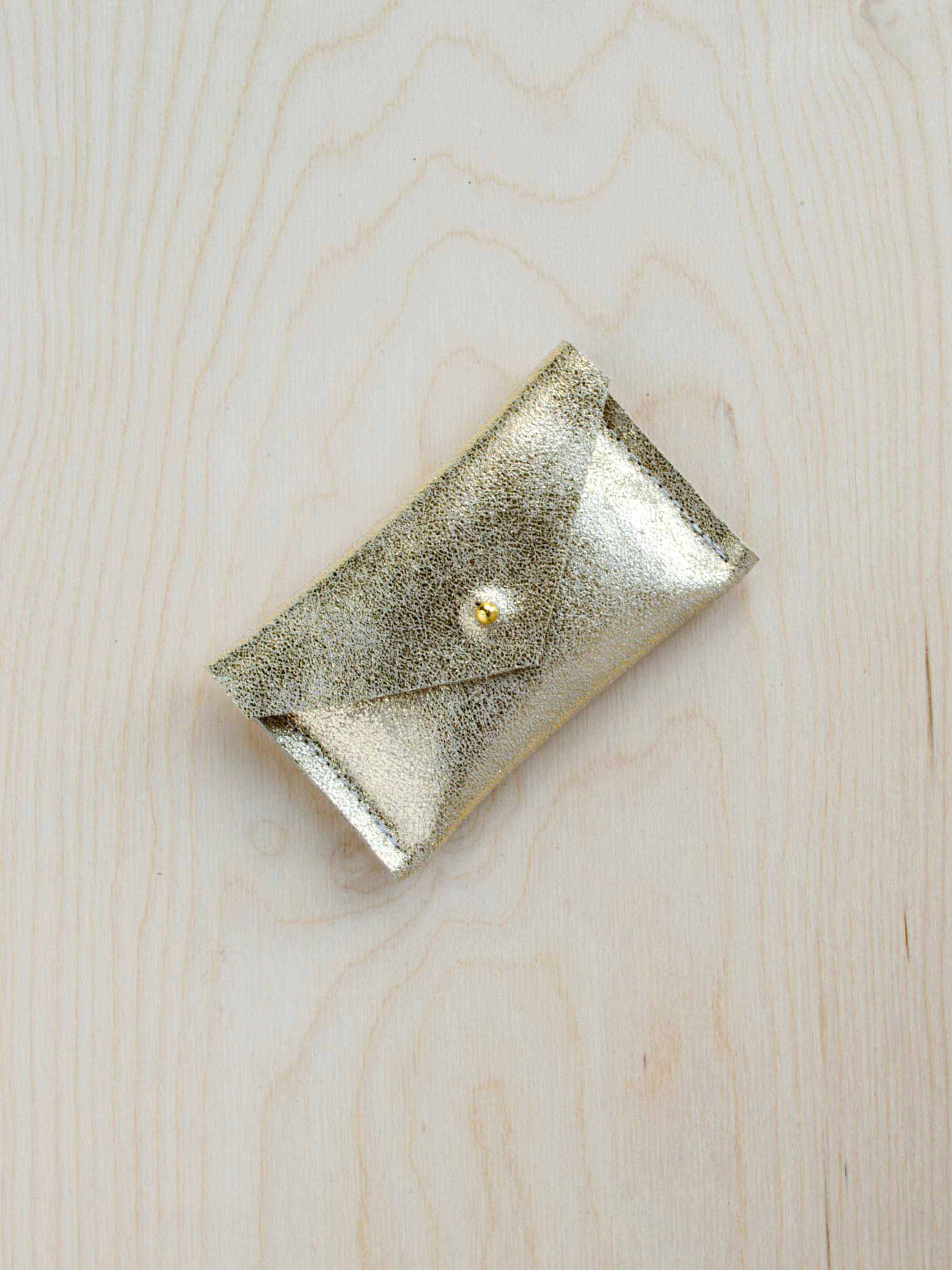 Gold leather wallet on a wooden background