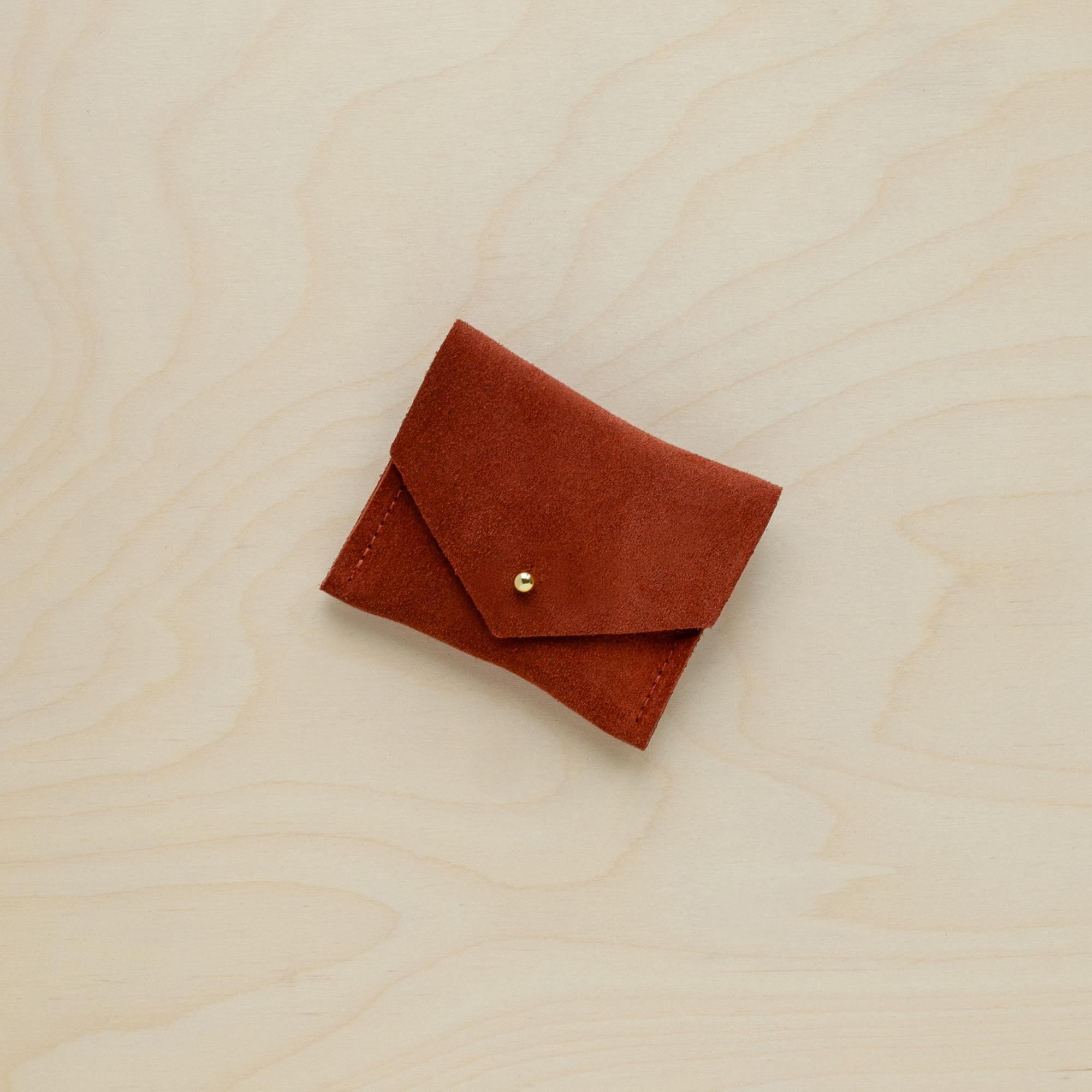 A suede Stitch Markers pouch in Chestnut brown. Complete with a stud for secure closing. 