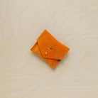 A suede Stitch Markers pouch in clementine orange. Complete with a stud for secure closing. This pouch has been personalised.