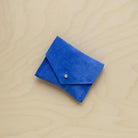 A suede Stitch Markers pouch in Cobalt Blue. Complete with a stud for secure closing.