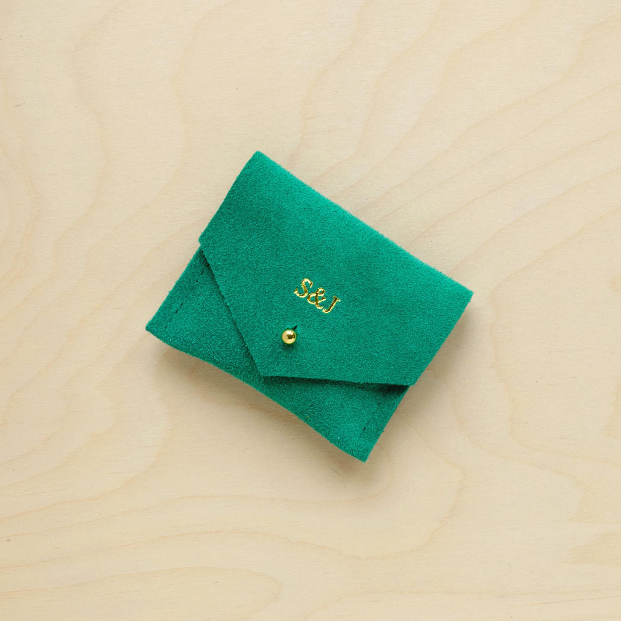 A suede Stitch Markers pouch in Jade Green. Complete with a stud for secure closing. This pouch has been personalised with couple initials. 