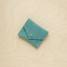 A suede Stitch Markers pouch in Mint Green. Complete with a stud for secure closing.