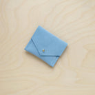 A suede Stitch Markers pouch in Pale Blue. Complete with a stud for secure closing.