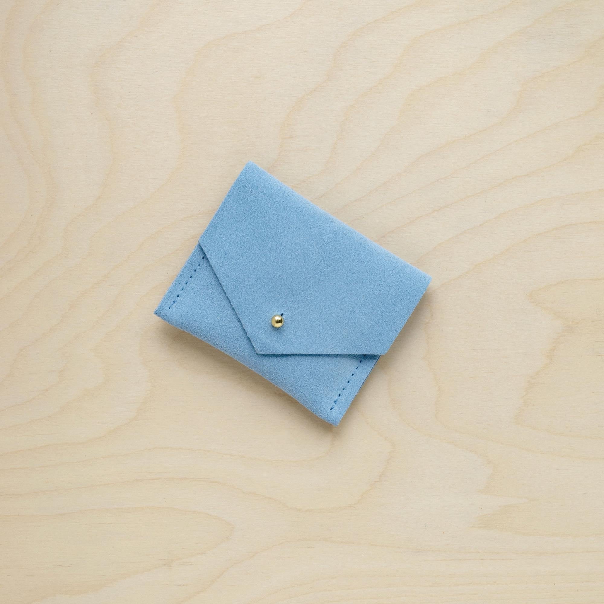 A suede Stitch Markers pouch in Pale Blue. Complete with a stud for secure closing.