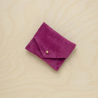 A suede Stitch Markers pouch in Plum Purple. Complete with a stud for secure closing.