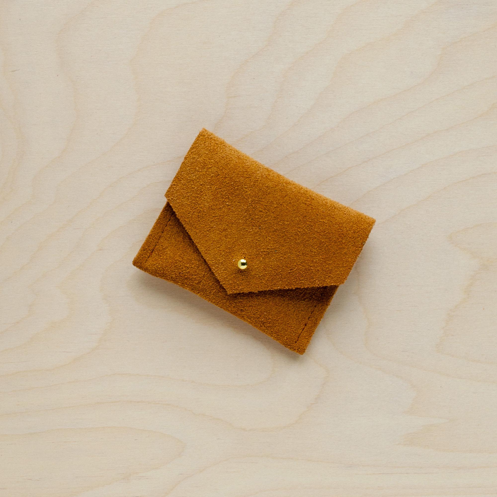 A suede Stitch Markers pouch in Tan brown. Complete with a stud for secure closing.