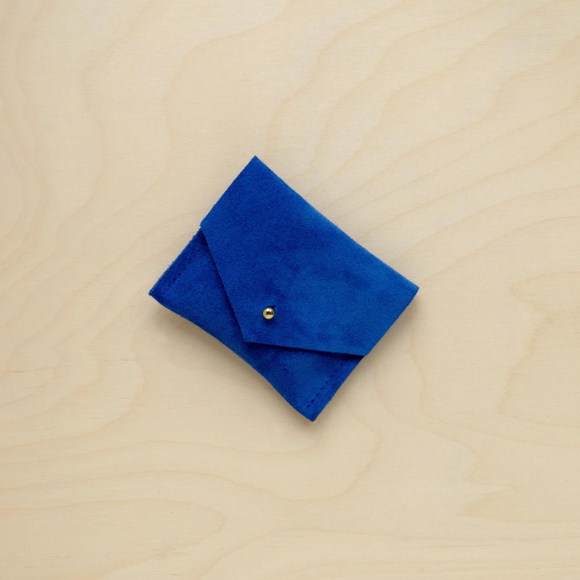 A suede Stitch Markers pouch in Ultramarine Blue. Complete with a stud for secure closing.